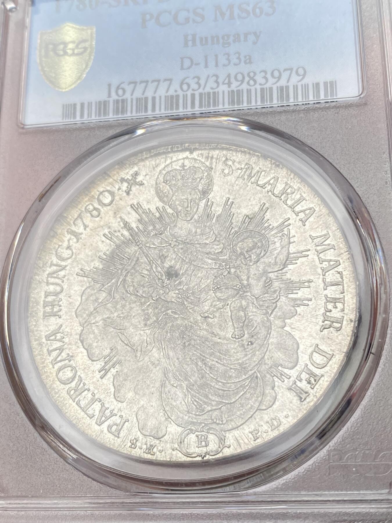 万国钱币拍卖第064期 PCGS MS63 1780年匈牙利神圣罗马帝国皇帝约瑟夫二世圣母抱婴泰勒 克雷姆琴察造币厂铸 高品罕见的神罗匈牙利洗礼 PC亚军分更高仅一枚 圣光环绕着圣母与圣子 背面两位大天使献上祝福 超级深铸银光充沛无减重痕罕见典藏级