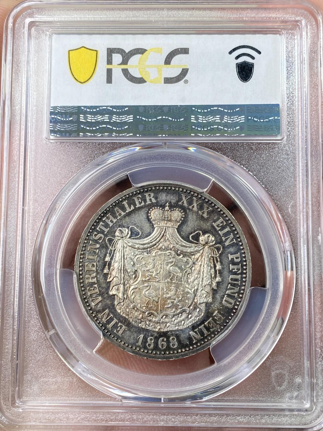 万国钱币拍卖第064期 PCGS PR63 1868年德国罗伊斯-上格莱茨精制纹章1泰勒 小邦中也是名列前茅的高难品种 仅单年发行7100枚 普制好品已是难得一见 精制更是凤毛麟角 精制镜面地板在靛蓝环五彩的加持下给人以强烈的视觉冲击 错过难再寻的顶级收藏品质