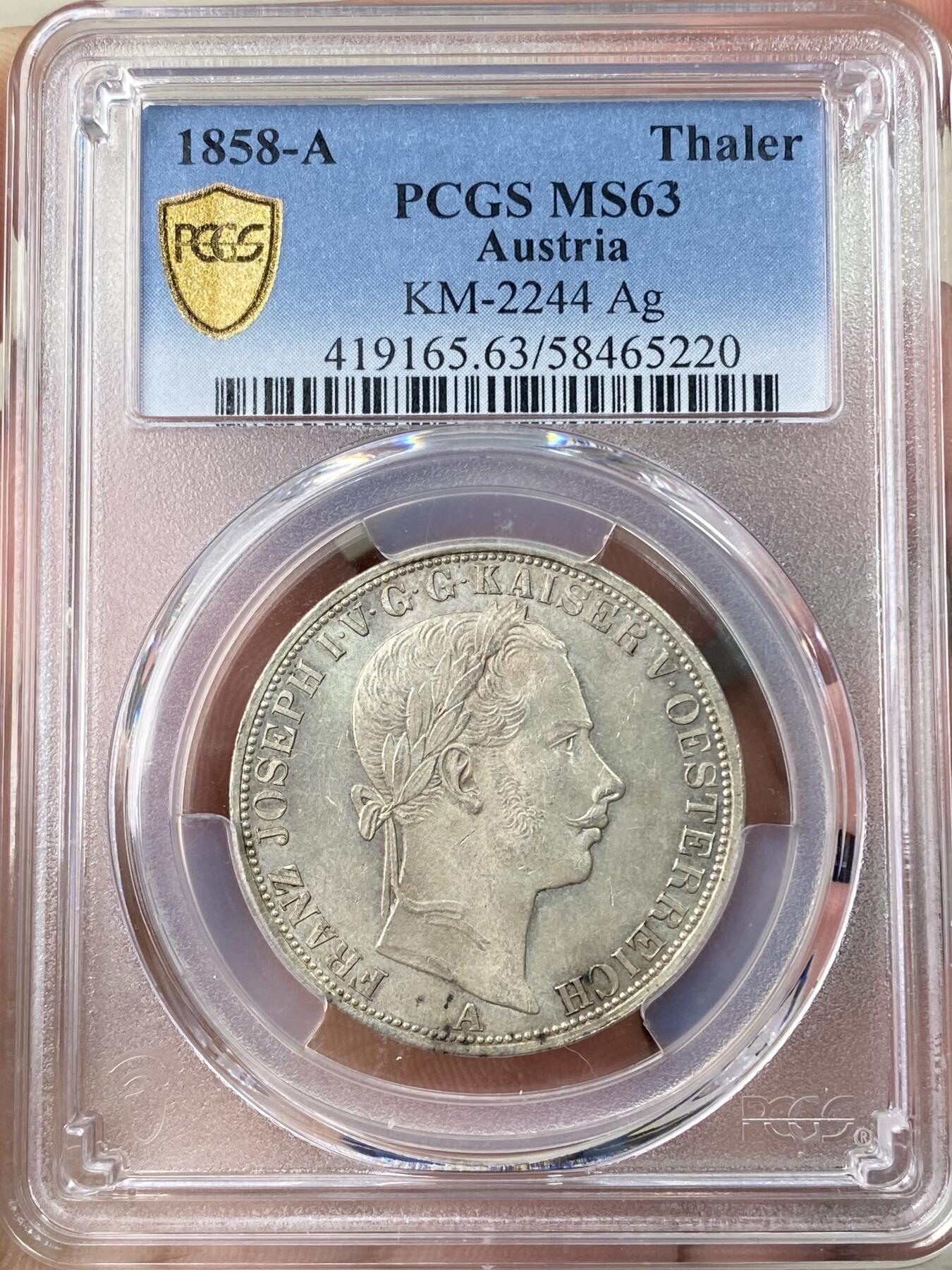 万国钱币拍卖第064期 PCGS MS63 1858年奥地利弗朗茨一世双头鹰流通1泰勒 维也纳货币协议的产物 与德国联合泰勒形制相同 车轮转光欧陆原味淡彩环绕极美收藏品质