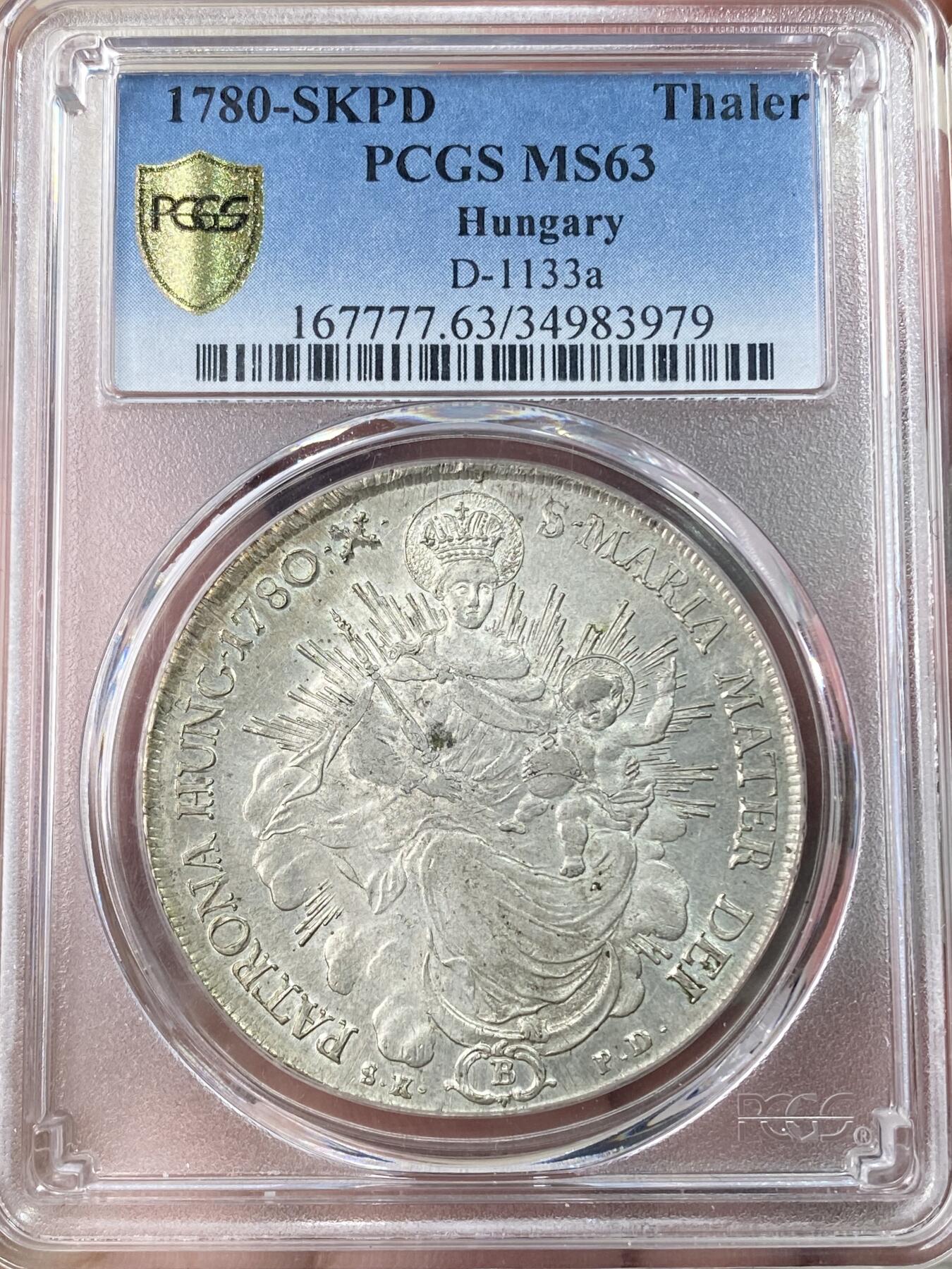 万国钱币拍卖第064期 PCGS MS63 1780年匈牙利神圣罗马帝国皇帝约瑟夫二世圣母抱婴泰勒 克雷姆琴察造币厂铸 高品罕见的神罗匈牙利洗礼 PC亚军分更高仅一枚 圣光环绕着圣母与圣子 背面两位大天使献上祝福 超级深铸银光充沛无减重痕罕见典藏级