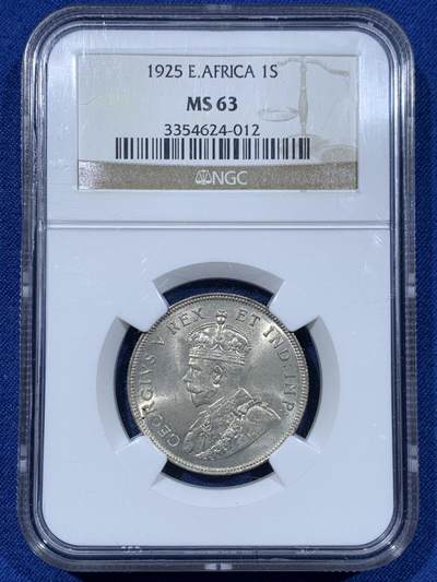 《竞宝斋》第477场 周日，周一 2场连拍 （全场包邮）欢迎送拍 - NGC MS63 东非1925年乔治五世1先令银币，原光，最大面值主币。肌肉虬结的雄狮漫步于乞力马扎罗山下，图案设计极富特色。老N盒保障，银光丝滑。此前竞宝斋同分1008元不含佣成交