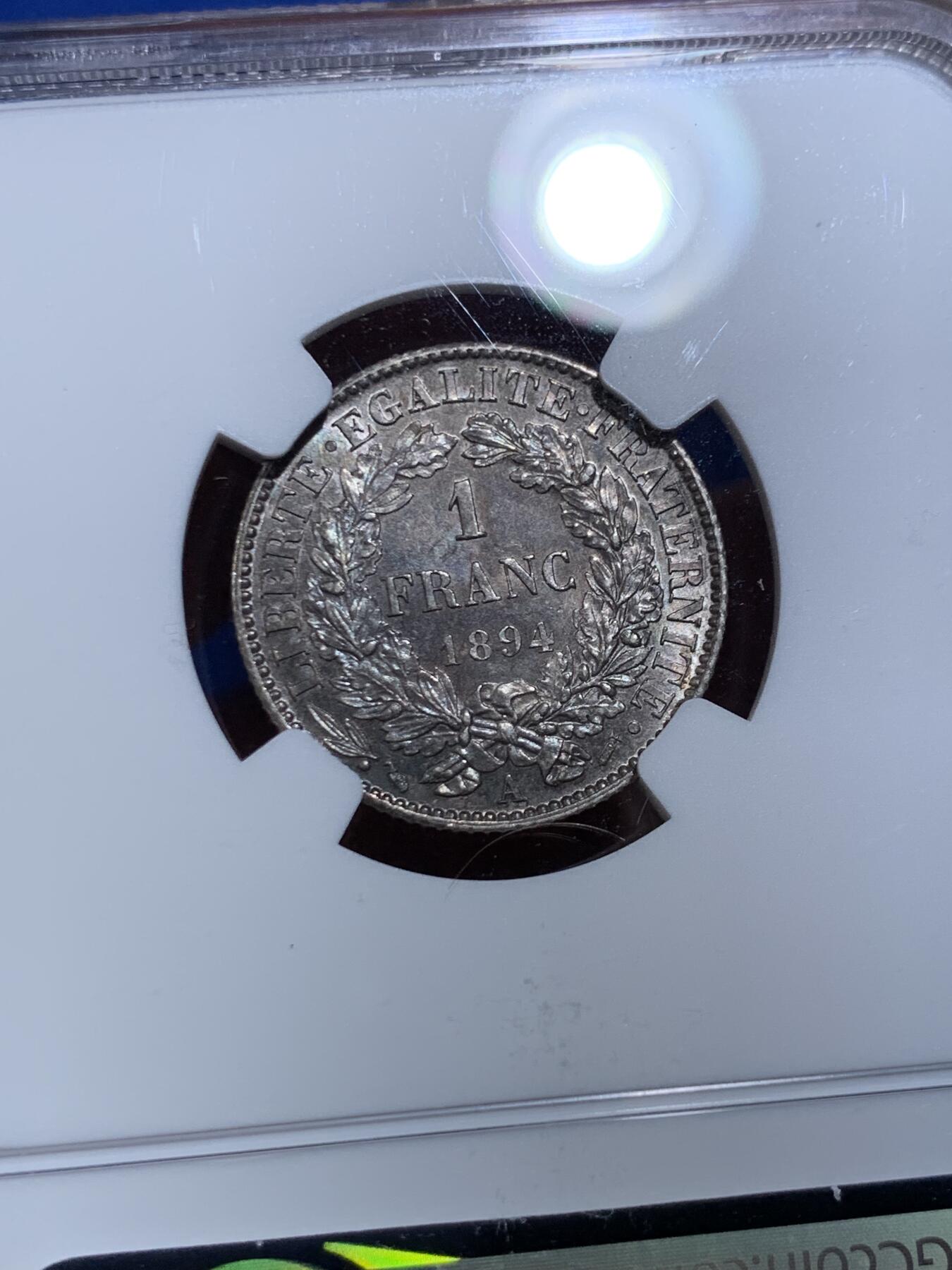 《竞宝斋》第477场 周日，周一 2场连拍 （全场包邮）欢迎送拍 NGC MS63 法国1894A谷物女神1法郎银币 原光未流通，实物很好，背面有种很漂亮少见的靛蓝彩，难得好品。