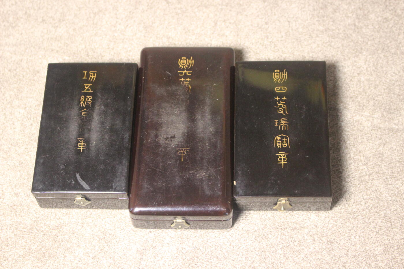 明治五等金鵄、六等旭日、四等瑞宝套装，章体和略章装裱在玻璃木相框中，套装整体非常厚重，章体日常佩戴品相，珐琅轻微缺损，原盒保存完好