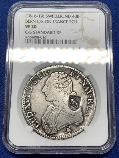 《竞宝斋》第478场 周日，周一 2场连拍 （全场包邮）欢迎送拍 - NGC VF20 瑞士加盖40B法国路易十六1791A埃居大银币 罕见1816-1819年期间瑞士官方加盖银币 难得有分好品 1799年苏黎世击败苏瓦洛夫后，瑞士重返法国轨道。各州实行“姐妹”共和国制度，日内瓦并入法国。1813年，瑞士联邦脱离法国联盟，重新获得独立，各州获得自由。革命之前和期间，瑞士充斥着六磅硬币，这些硬币在大多数州自由流通。伯尔尼州和沃州决定对这些皇冠进行标记，并给予它们相当于