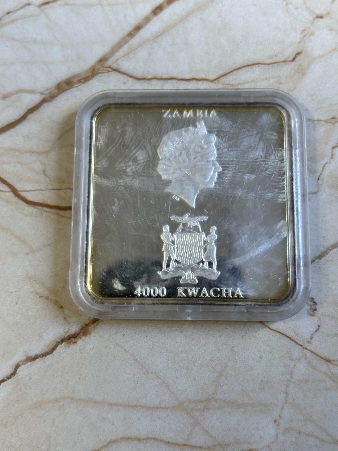 第197期拍卖 赞比亚2001年抽象画橱窗里的猫方型精制纪念银币，50克，999银，发行5000枚，塑料盒有瑕疵，币有氧化