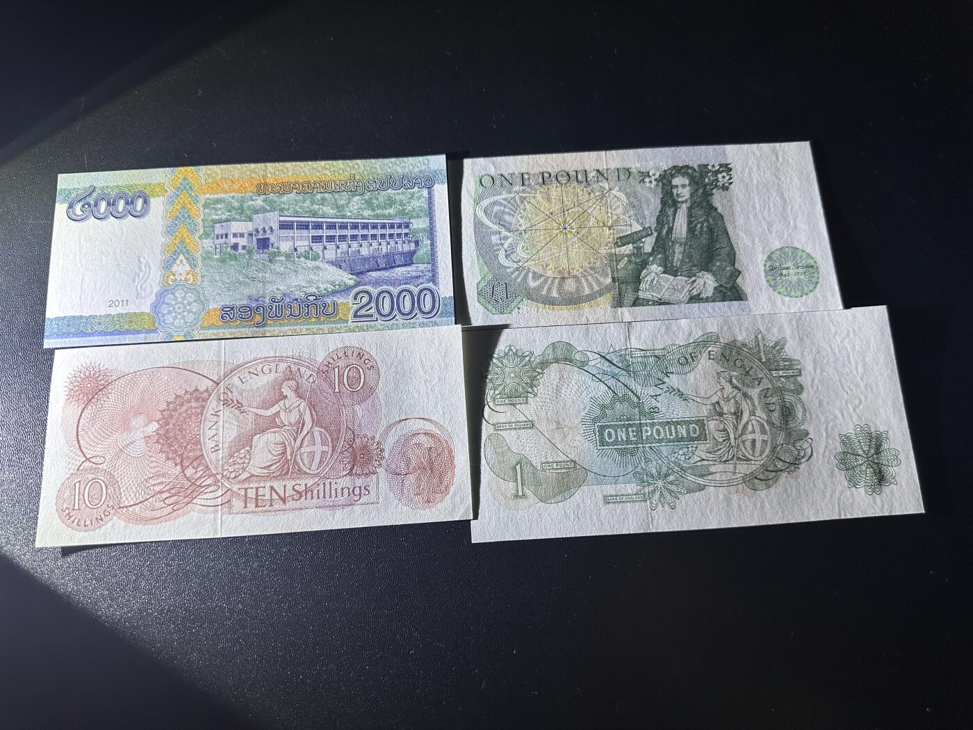 《外钞收藏家》第六百二十六期（精品场）（长期征集拍品、欢迎藏友们联系合作） 老挝2000+英国D序列1镑+C序列10先令和1镑 4张一起 全新UNC