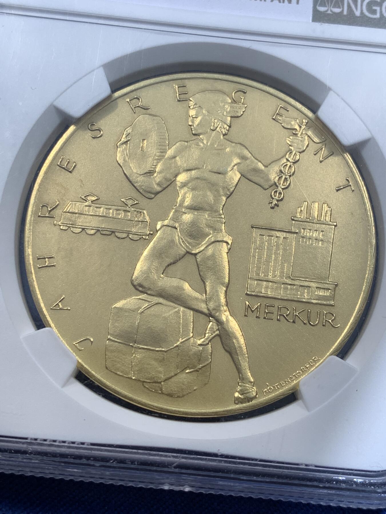 《竞宝斋》第481场 周日，周一 2场连拍 （全场包邮）20级店铺 欢迎送拍 NGC MS68 奥地利 日历金章 麦稀奇首见品种 罕见大金章 章面商业之神墨丘利与齿轮电车等工业元素完美融合 设计大气 雕刻极深 历经半个多世纪 依然保持着如新铸般的极美光泽与极致细节 不可多得的顶级藏品 30.61克 大规格 能查到的同款最近成交记录 4080美元成交 边铭图片太难拍了 具体见最后一张图 自行判定后出价