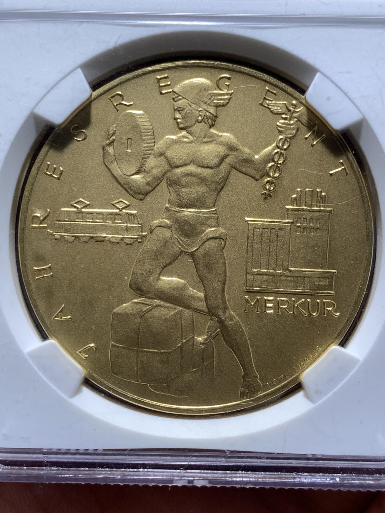 《竞宝斋》第481场 周日，周一 2场连拍 （全场包邮）20级店铺 欢迎送拍 NGC MS68 奥地利 日历金章 麦稀奇首见品种 罕见大金章 章面商业之神墨丘利与齿轮电车等工业元素完美融合 设计大气 雕刻极深 历经半个多世纪 依然保持着如新铸般的极美光泽与极致细节 不可多得的顶级藏品 30.61克 大规格 能查到的同款最近成交记录 4080美元成交 边铭图片太难拍了 具体见最后一张图 自行判定后出价