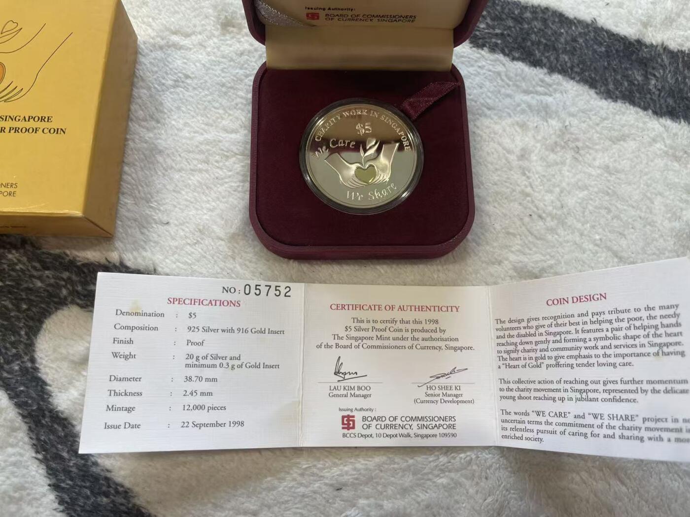 ❤️【币观天下】❤️ 第349期钱币拍卖场- 2026.4.24周五晚上6点半场 长期征集拍品  新加坡1998年爱心慈善精制纪念银币 含0.3克镶嵌金 20克银+0.3克金 盒证全齐 
