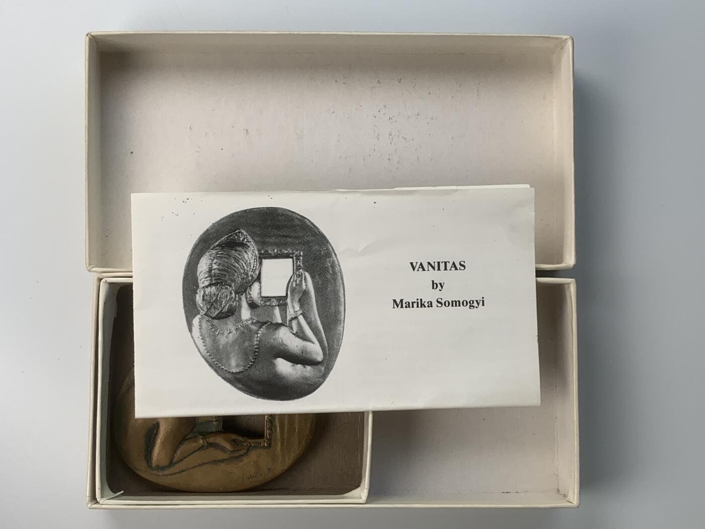 掌中浮雕-藏着的欧洲第059场 1986年美国章币协会#113号章【照镜子的女子】，71 X 58mm，206.5g，原盒带说明，设计雕刻家：Marika Somogyi  ，正面：Woman looking in mirror （照镜子的女子）， 反面：Devil watching through mirror （镜后偷窥的魔鬼），铜章发行量：750枚