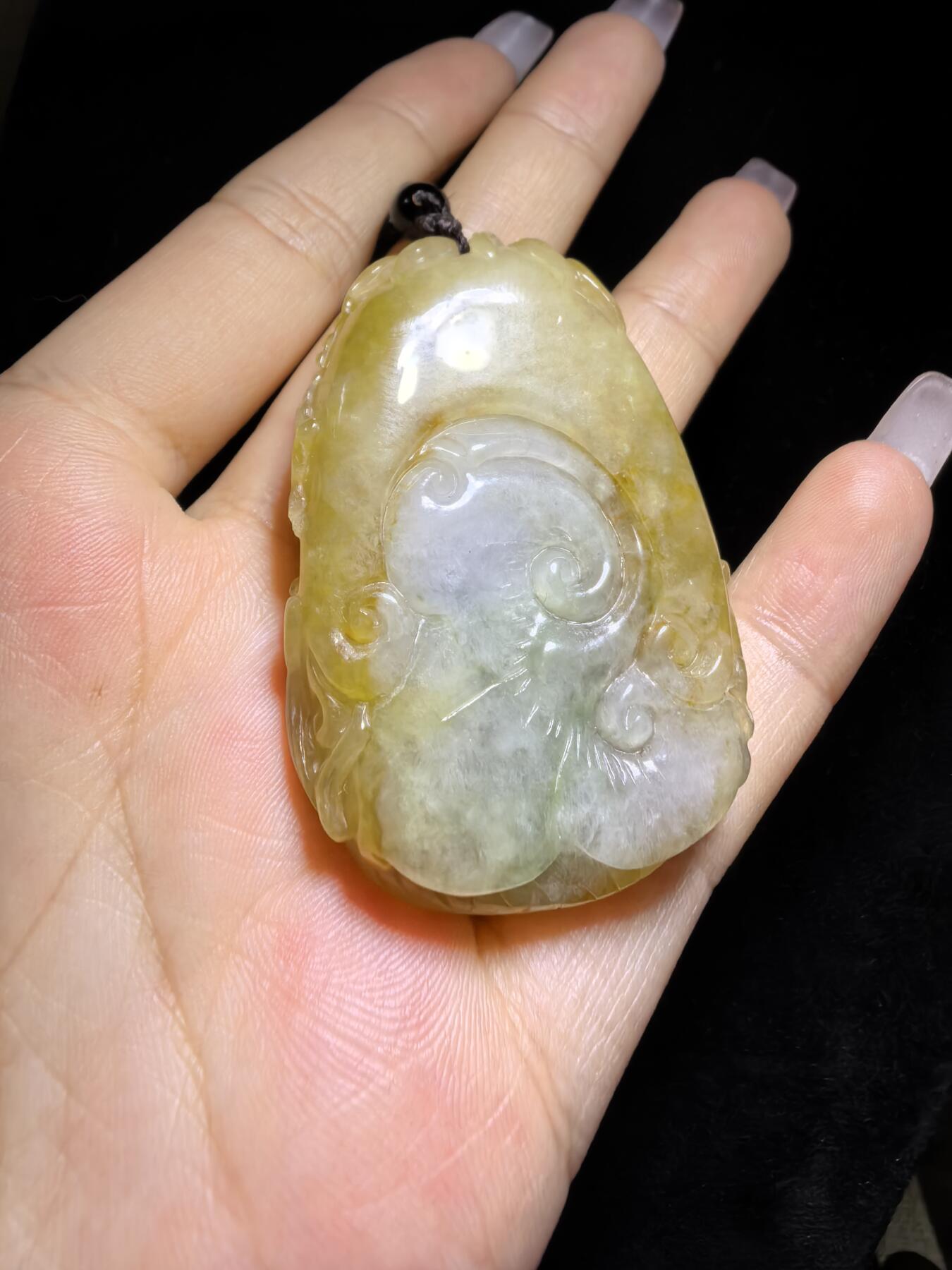 精选天然黄翡龙牌，色泽温润如蜜，通透莹亮。整料随形巧雕，龙纹苍劲灵动，盘曲间尽展威严；背面如意纹饰，线条流畅，寓意顺遂安康。黄翡为“金”，龙主祥瑞，金运与贵气相融，是随身护佑的雅器，亦是收藏赏玩的佳选。5.2cm*3.5cm*1.3cm