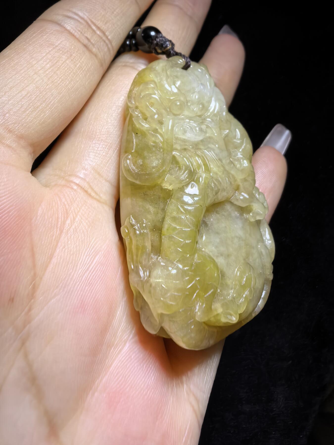 精选天然黄翡龙牌，色泽温润如蜜，通透莹亮。整料随形巧雕，龙纹苍劲灵动，盘曲间尽展威严；背面如意纹饰，线条流畅，寓意顺遂安康。黄翡为“金”，龙主祥瑞，金运与贵气相融，是随身护佑的雅器，亦是收藏赏玩的佳选。5.2cm*3.5cm*1.3cm