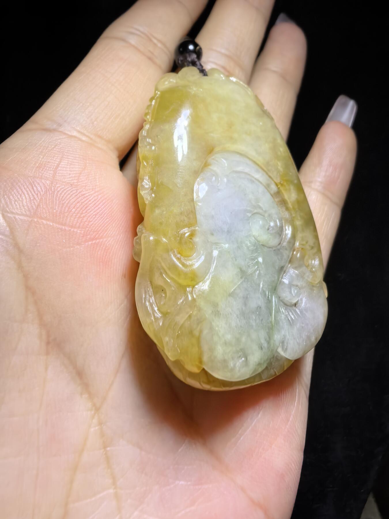 精选天然黄翡龙牌，色泽温润如蜜，通透莹亮。整料随形巧雕，龙纹苍劲灵动，盘曲间尽展威严；背面如意纹饰，线条流畅，寓意顺遂安康。黄翡为“金”，龙主祥瑞，金运与贵气相融，是随身护佑的雅器，亦是收藏赏玩的佳选。5.2cm*3.5cm*1.3cm