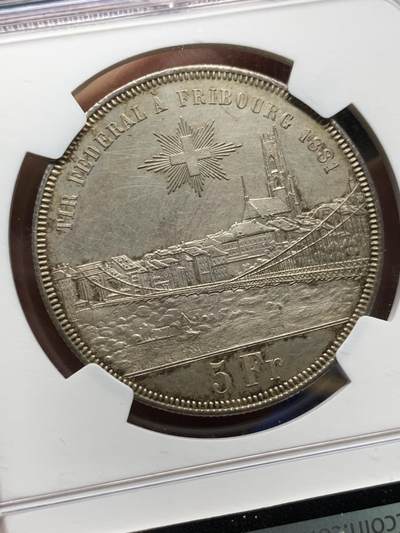 《竞宝斋》第484场 周日，周一，周二 3场连拍 （全场包邮）20级店铺 欢迎送拍 NGC UNC 瑞士1881年弗莱堡射击节5法郎大银币，景观刻画细致。